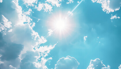 vibrant blue sky with bright sunlight peeking through fluffy white clouds on a clear day.
