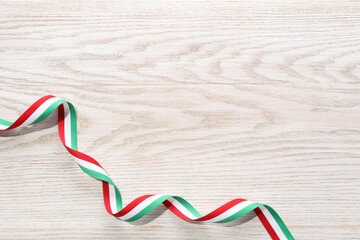 Wall Mural - Ribbon in colors of Hungarian flag on white wooden background, top view. Space for text