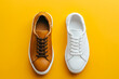 © valentyn640 - Two white and brown sneakers on a yellow background