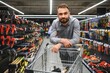 © Serhii - Portrait of happy mature man standing in hardware store