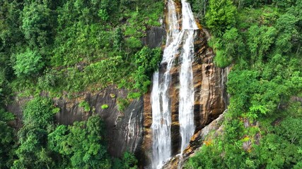 Poster - Top view of a sprawling Waterfall , nestled within the dense greenery of a tropical forest at Doi Inthanon National Park, Chiang Mai Province, Thailand 4K Aerial view footage.
