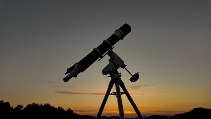 Wall Mural - Preparing for night sky observing with a astronomical telescope just before sunset.