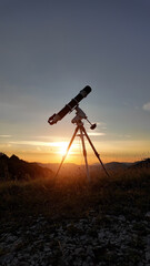 Wall Mural - Preparing for night sky observing with a astronomical telescope just before sunset.