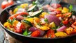 © tashechka - A close-up of colorful grilled vegetables, including peppers and onions, in a steaming hot skillet.