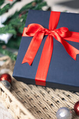 Black gift box with a red bow