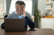 © Wosunan - Senior businessman working from home with emotion and postures