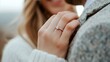 © ArtStockVault - Wedding Ring Focus. Couple Celebrating Engagement with Sparkling Diamond Ring Close-Up on Hand in Cozy Fall Sweater Outdoors