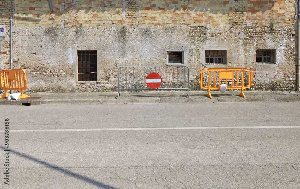 No entry warning sign, temporary fences and safety striped tape on ...