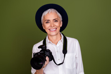 Sticker - Photo of shiny attractive lady photographer dressed white shirt cap smiling filming camera empty space isolated khaki color background