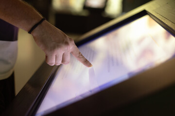 Wall Mural - Man hand using touchscreen display of kiosk, close up view of male finger touching screen