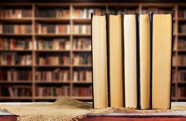 Wall Mural - stack of books in library on wooden table