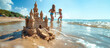 © Vadym Hunko - Detailed sandcastle on a beach with two children playing near the water under a clear blue sky.
