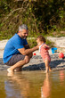 © marabelo - Young caucasian family having a picnic at the lake on a sunny afternoon.