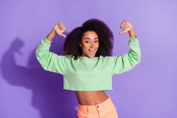 Poster - Photo of american young funny egocentric girl wearing green trendy top pointing fingers herself isolated on purple color background