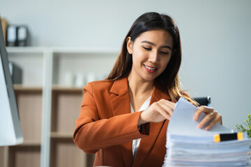 Wall Mural - Business concepts, business woman working in the work area with laptop computer and data sheets at the desk.