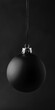 © Vlad - Black Christmas Ornament. Festive Bauble Hanging on Dark Background
