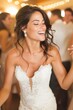 © Mykhailo Podolian - Radiant bride in white lace gown laughing joyfully at her wedding celebration