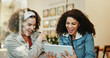 © peopleimages.com - Cafe, tablet and friends with laugh for joke, streaming online and entertainment video for bonding together. People, women and digital with happiness for meme, social media and chat in coffee shop