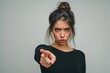 © Igor - woman with angry expression looking at camera and pointing with index finger in accusatory way Isolated