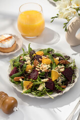 Wall Mural - Delicious salad with baked beetroots and oranges on plate