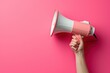 © Artistic Images - Megaphone or speaker in female hand on pink background. Woman holding loudspeaker on color background, closeup view. Generated AI