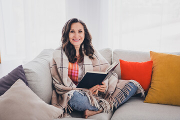 Sticker - Photo of pretty cheerful lady wear plaid shirt smiling reading interesting novel indoors room home house