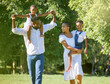 © peopleimages.com - Black family, walking and happy in park with love for bonding together, fun activity and care outdoor. People, parents or kids in nature for summer holiday, security or support in natural environment