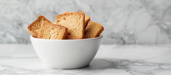 Poster - Rusk in a white bowl showcasing a crispy texture against a clean background with copy space image