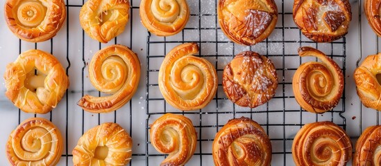 Poster - Variety of homemade puff pastry pastries like palmiers and elephant ears displayed on a cooling rack with copy space image