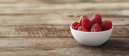 Poster - A white bowl containing a raspberry fruit placed on a wooden surface with empty space for additional images