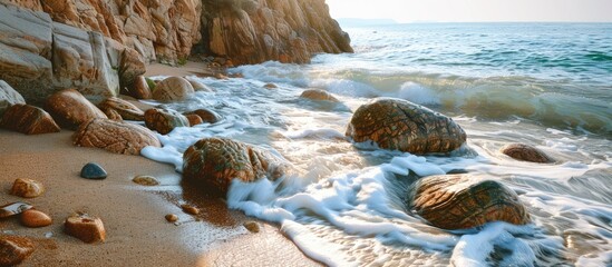 Poster - Scenic view of rocks waves and coastline on a beach with a wide copy space image