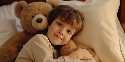 Wall Mural - A cute boy hugging a teddy bear in bed, showing the innocence and warmth of childhood.