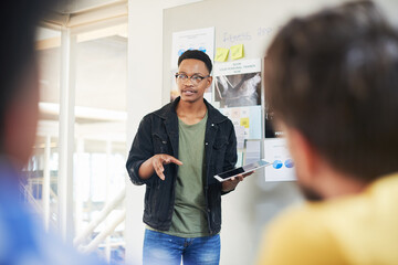 Poster - Businessman, coaching and presentation with tablet in meeting for training staff, ideas or mission at office. Man, speaker or employee talking to group with technology for agenda or tasks on project