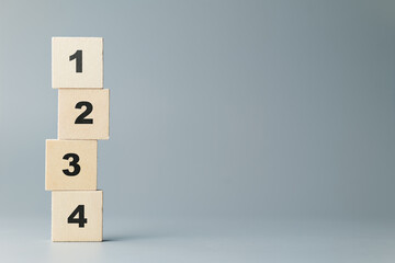 Fototapete - Stack of thin wood blocks with orderly numbers of one, two, three, and four on gray background, method, instruction lists
