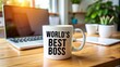 © thanakrit - World's Best Boss Mug on Desk with Laptop.