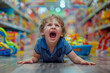 © vejaa - Child throwing a tantrum in toy store. Spoiled little boy lying on store floor and screaming, because his parents do not want to buy him toys or satisfy his desires. Bad behavior, childish whims