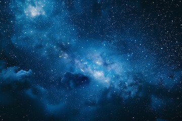 A starry night sky with deep blue hues, featuring a scattering of stars and nebulae against a dark and mysterious background. Ideal for celestial-themed designs or space exploration themes.