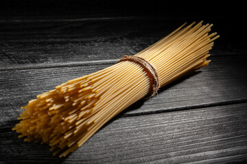 Wall Mural - pasta spaghetti on wood background