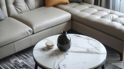 Wall Mural - Marble table with a black vase and small bowl in front of a beige sofa.