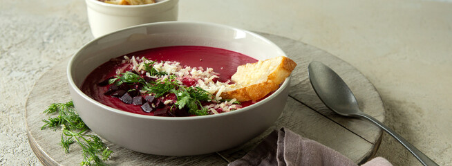 Wall Mural - plate of creamy beet soup with parmesan croutons on the table