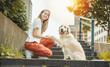© Louis-Paul Photo - Portrait of teenage girl having fun outside with golden retriever