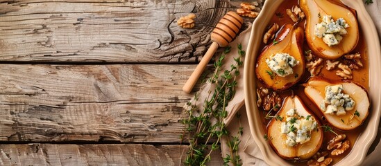 Sticker - Top down view of delicious baked pears adorned with nuts blue cheese thyme and honey in a baking dish on a wooden table with space available for adding text next to the image. Copy space image