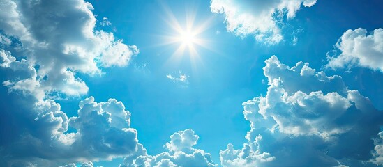 Poster - A sunny summer day with a blue sky decorated by fluffy white clouds creates an empty background ideal for a copy space image