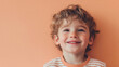 © Pug - Cheerful boy against a soft peach backdrop