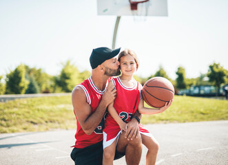 Basketball, sport with a dad and daughter training on a court outside for leisure fitness and fun