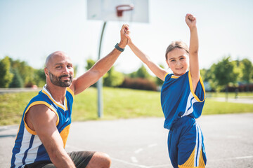 Basketball, sport with a dad and daughter training on a court outside for leisure fitness and fun