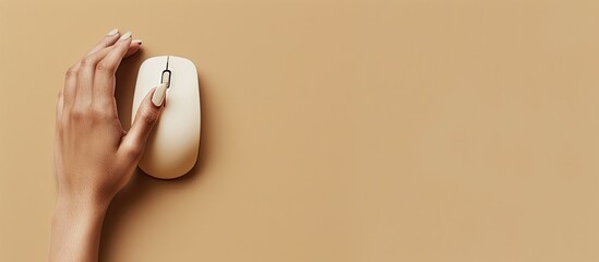 Poster - top view of a woman using a modern wired computer mouse on a beige background with space available f