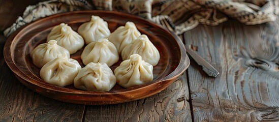 Canvas Print - Georgian Khinkali dumplings displayed on a wooden table in a copy space image