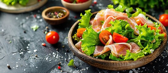 Canvas Print - Jamon salad with lettuce tomato dressing on the table in a rustic food background suitable for keto or paleo diets with copy space image