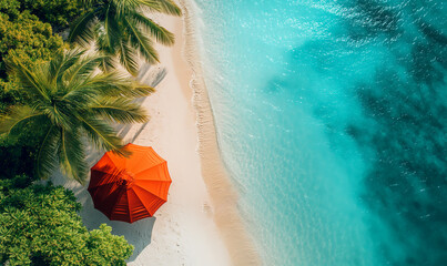 An orange parasol on a tropical beach with palm trees